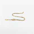 Gold oval cable chain bracelet on white background, product photo