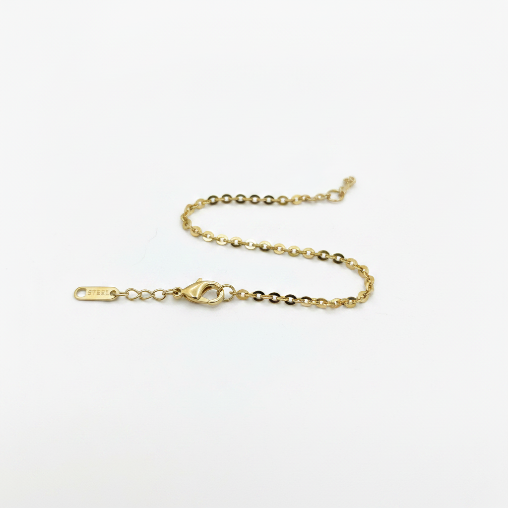 Gold oval cable chain bracelet on white background, product photo