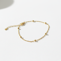 Gold satellite ball chain bracelet on white background, product photo