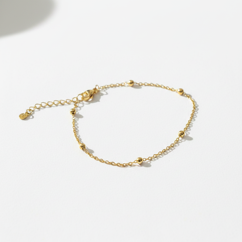 Gold satellite ball chain bracelet on white background, product photo