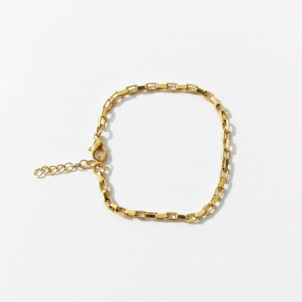Gold paperclip chain bracelet on white background, product photo